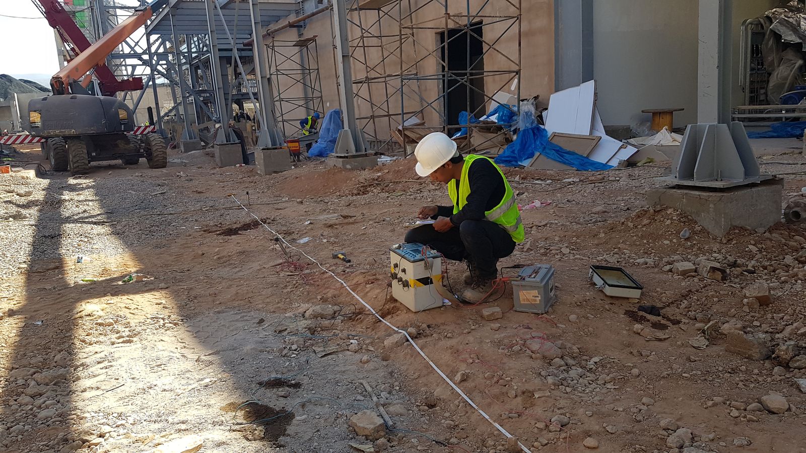 PROGREM technician carrying out soil measurements on a construction site
