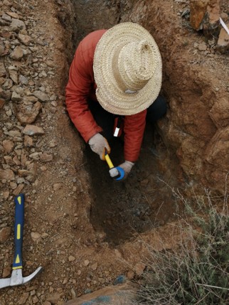 PROGREM geologist working inside an exploration trench
