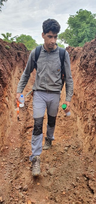 PROGREM geologist inspecting an exploration trench