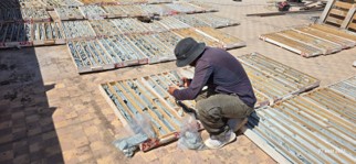 PROGREM geologist inspecting core boxes