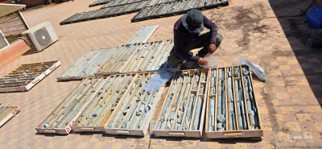 PROGREM geologist logging drill core and selecting samples