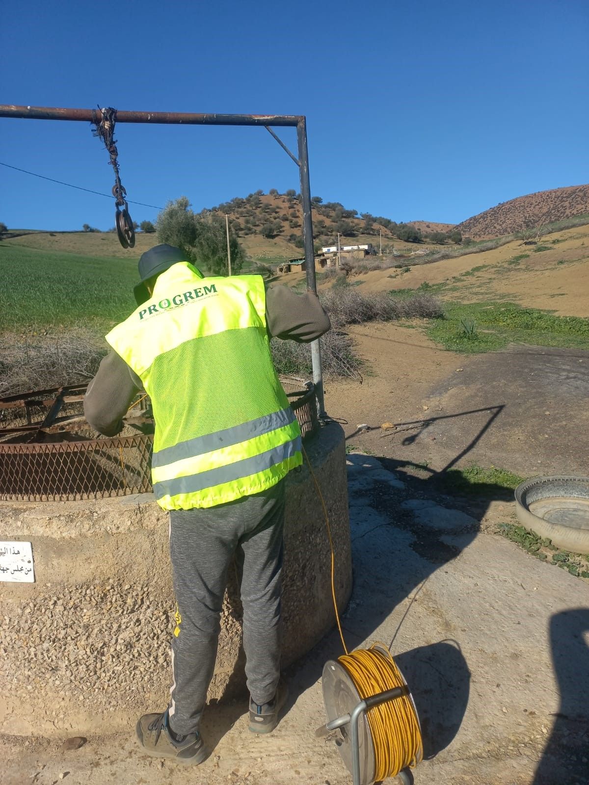 PROGREM technician measuring the groundwater level in a well