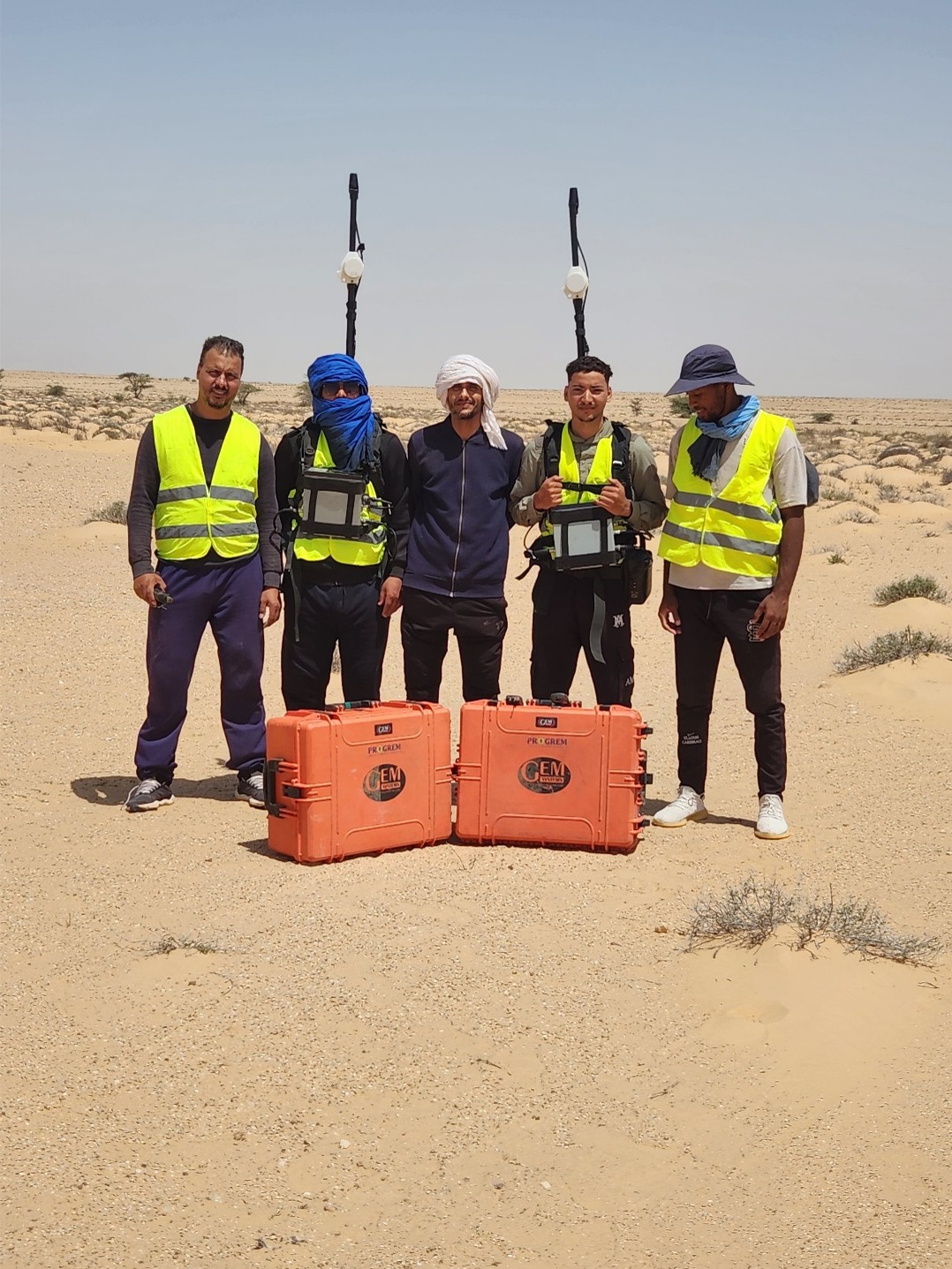 PROGREM field team with GNSS antennas and equipment cases