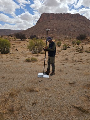PROGREM surveyor positioning a ground control point with a GNSS rover